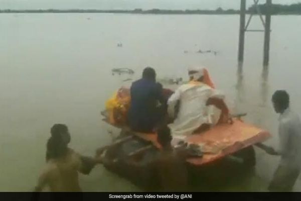 On Video, Newly Married Couple Cross Flooded Road Using Makeshift Boat News Image